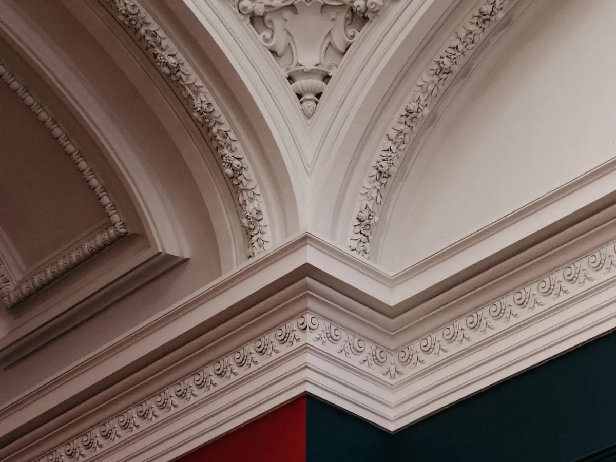 Ornate cornice against contrasting painted walls and ceiling