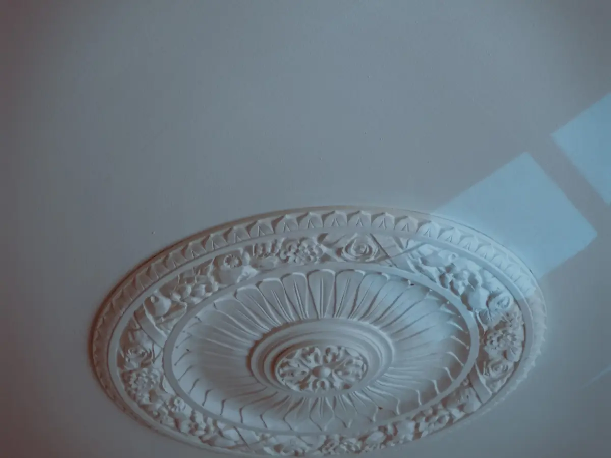 Cast plaster ceiling medallion with a leaf pattern