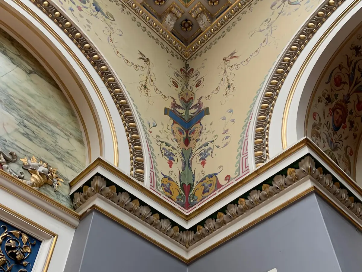Corner of a Victorian interior with painted cornice and decorative frieze