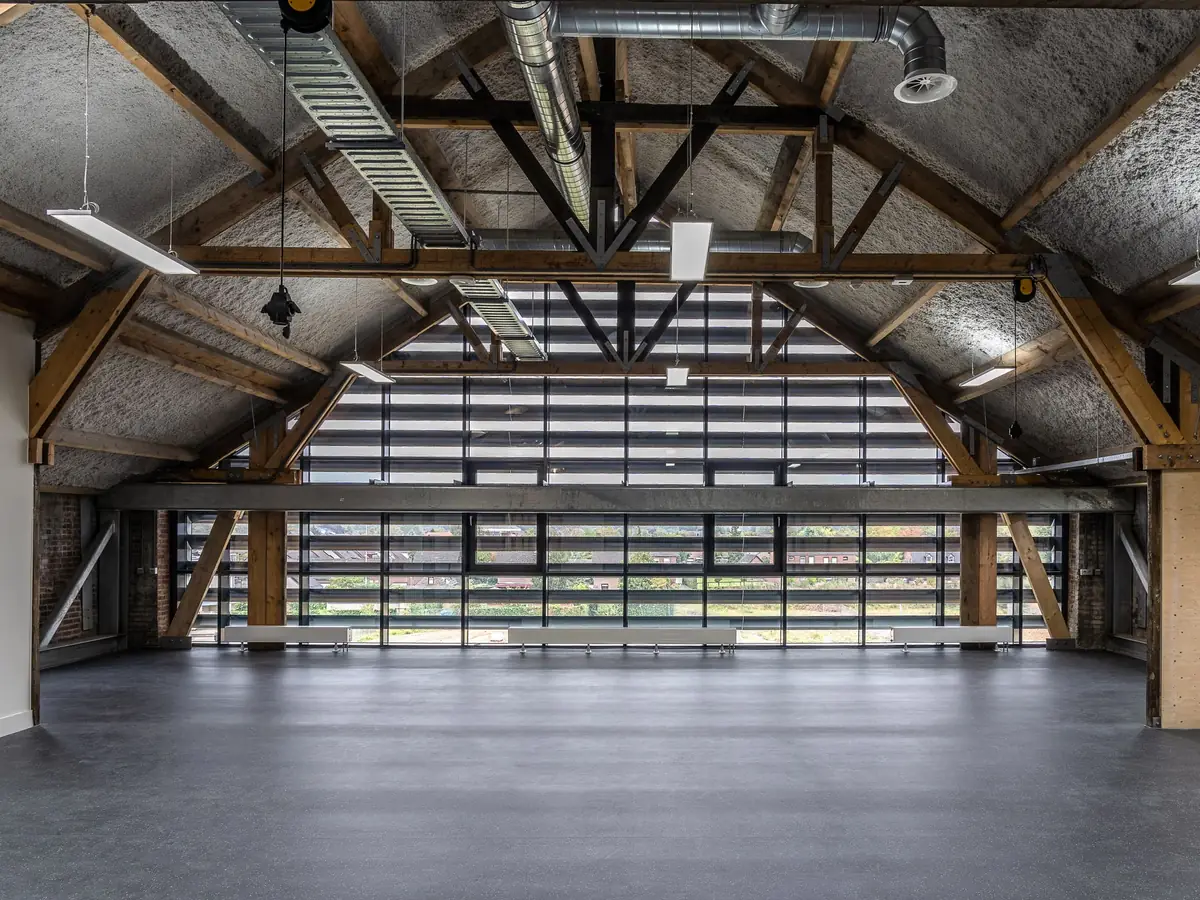 Large empty industrial hall with timber and steel structure