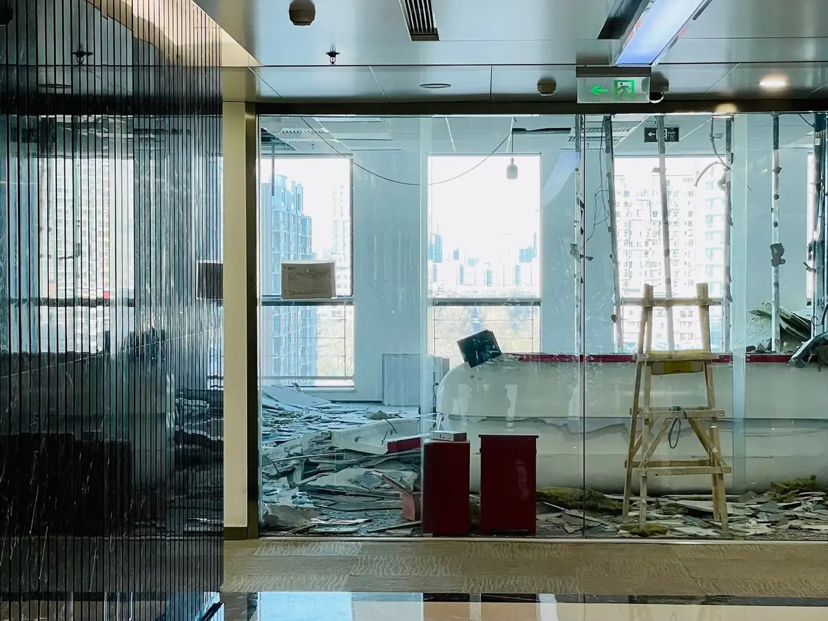 Empty office floor mid-refurbishment with the city visible through the glazing