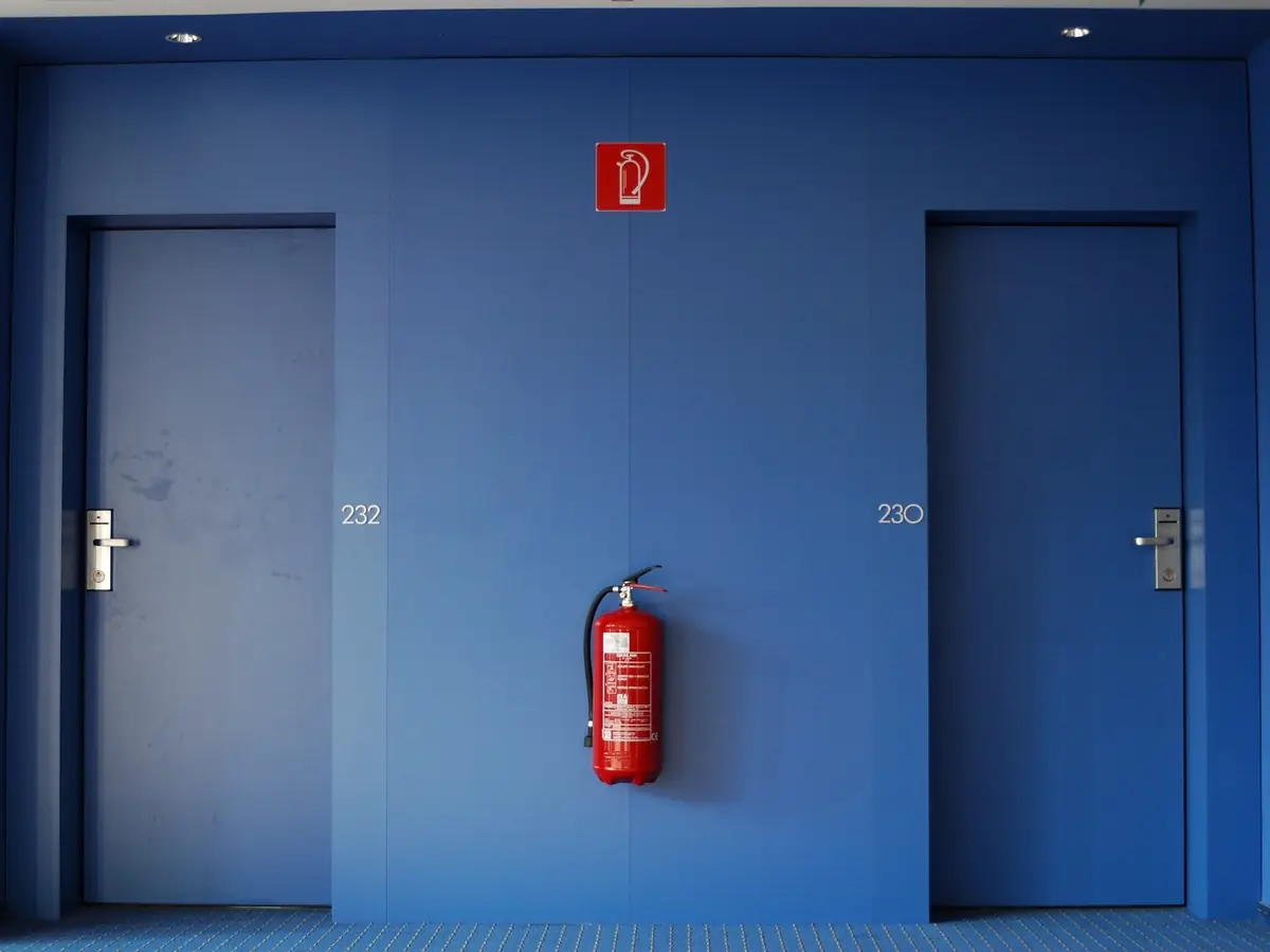 Fire doors and an extinguisher in a protected corridor