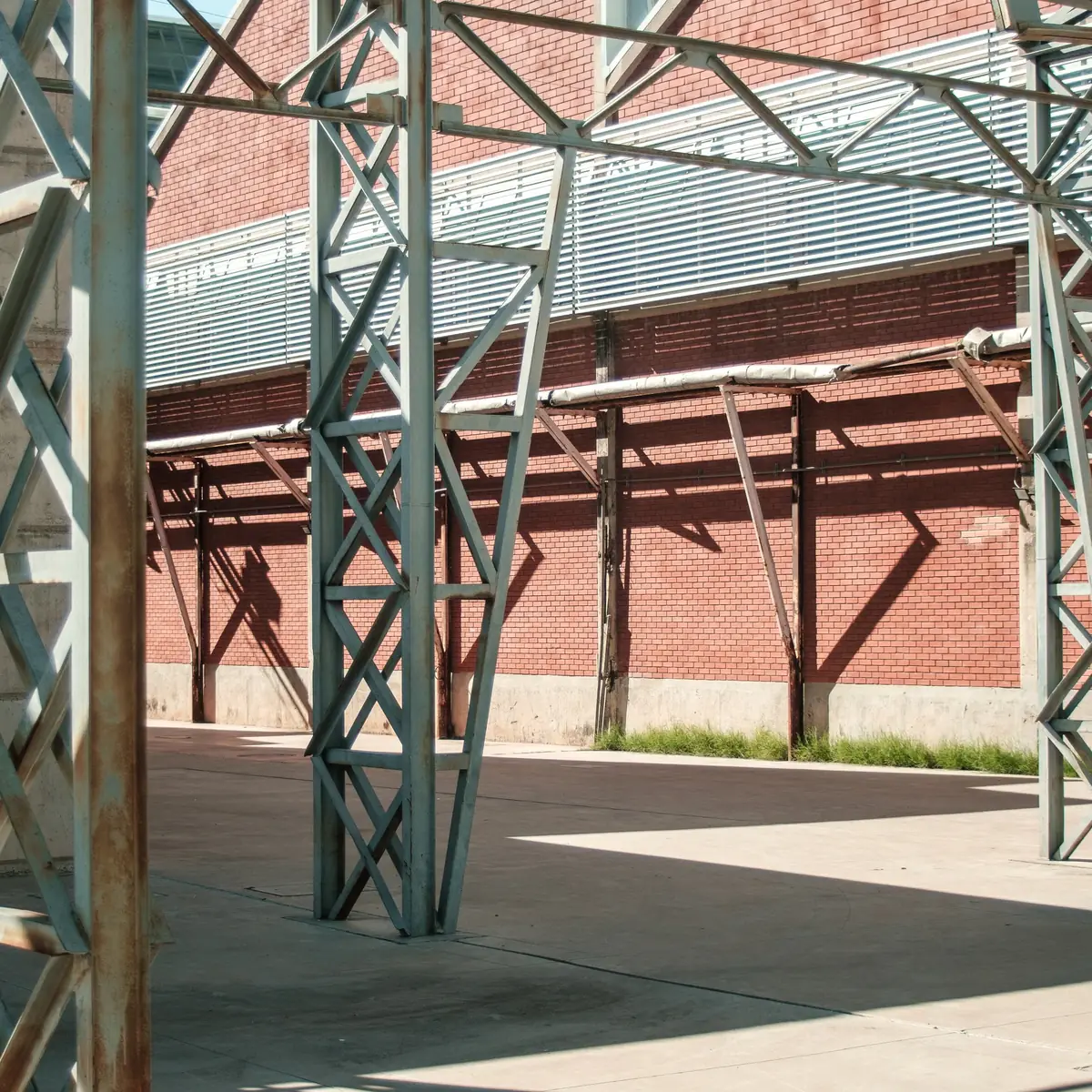 Structural steel frame against a brick building