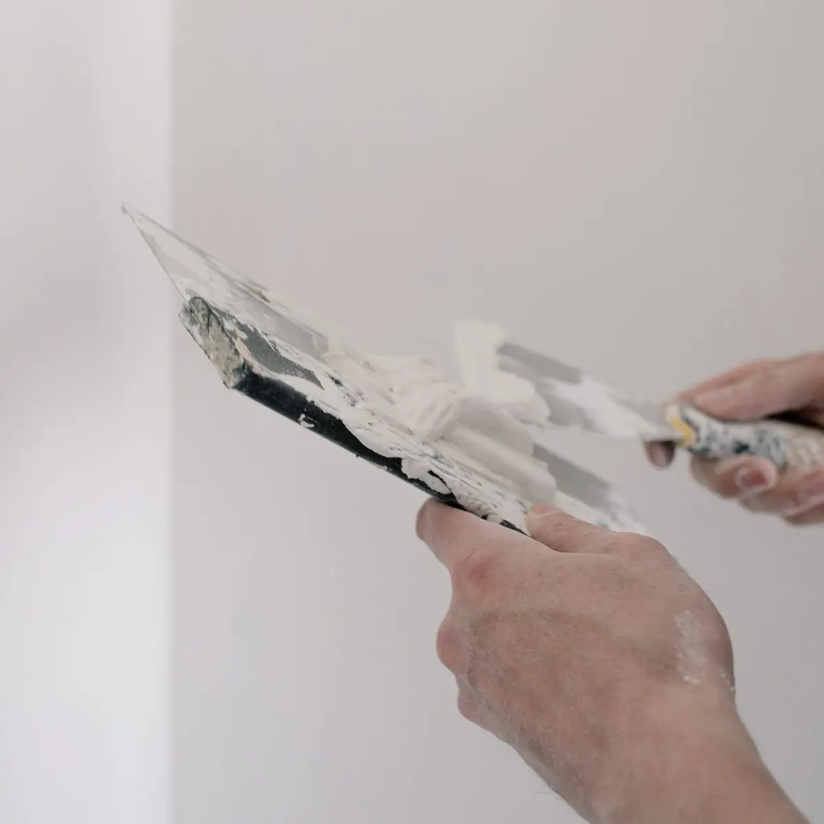 Loading finishing plaster from the hawk on to the trowel