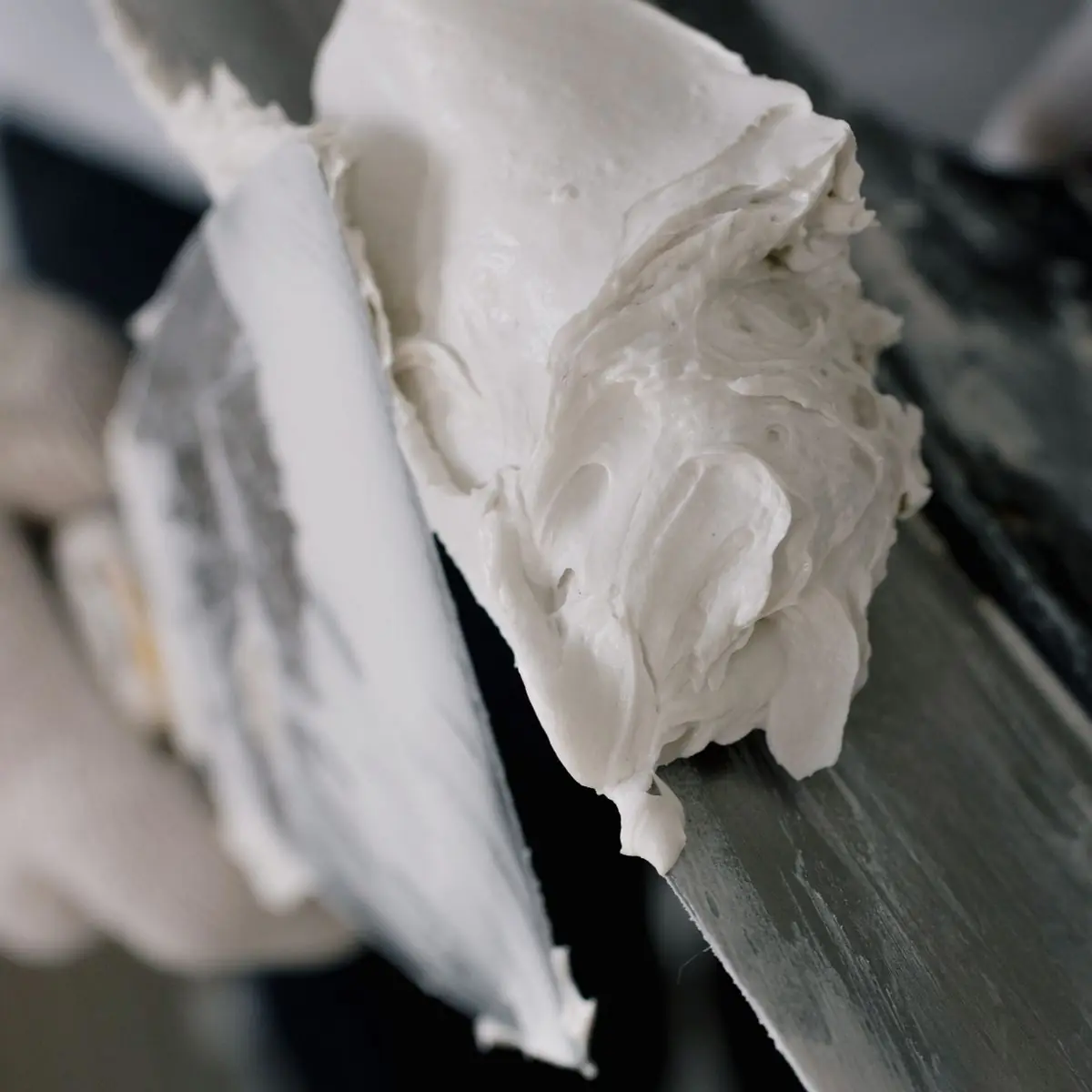 Finishing plaster gathered on the edge of a trowel