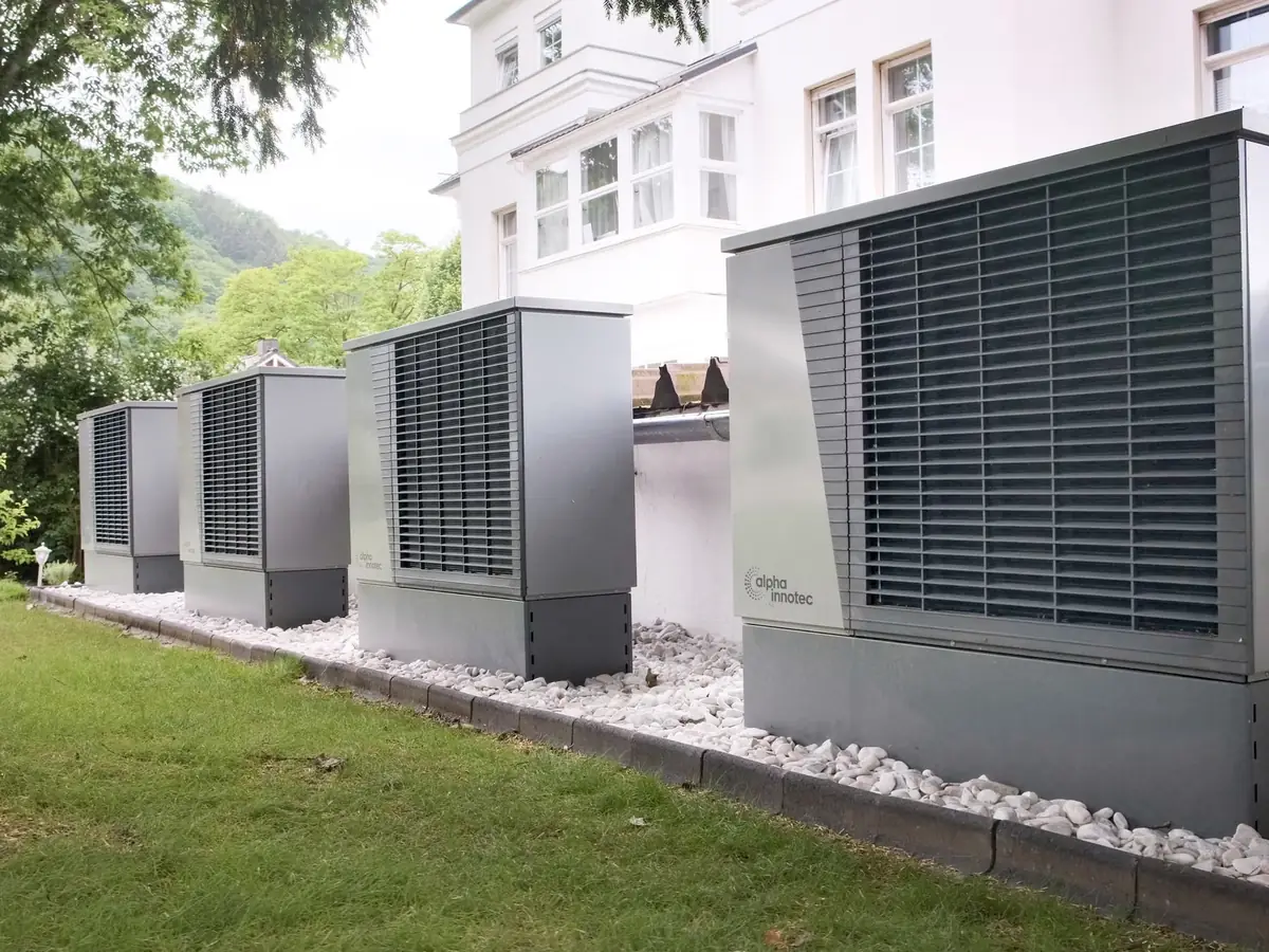 Row of air source heat pump units outside a building
