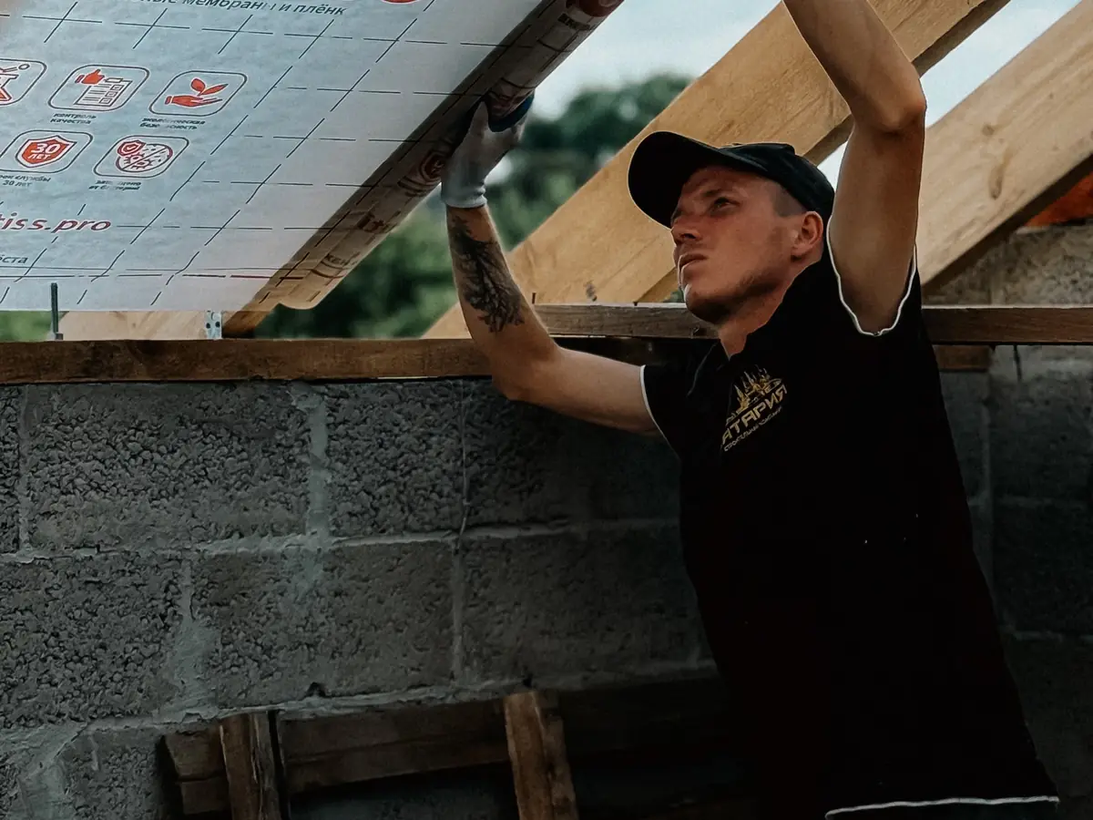 Fixing insulation and membrane to a building externally