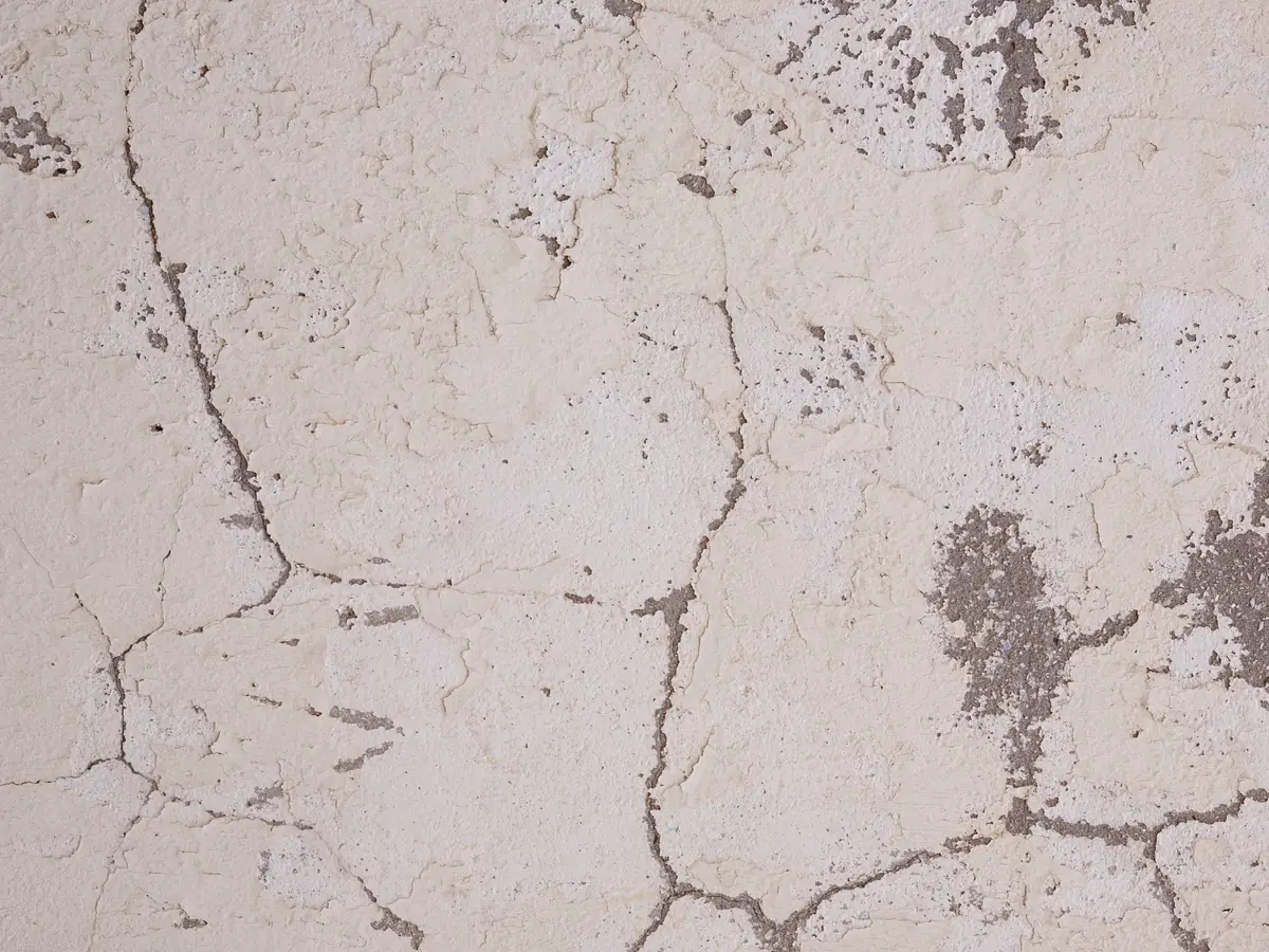 Old cracked render with a map of fine cracks across the surface