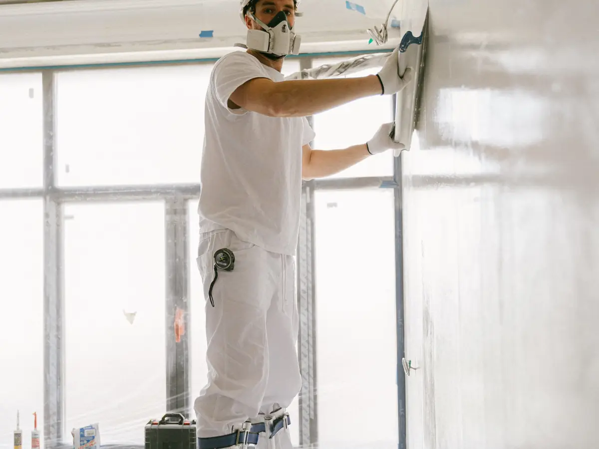 Operative in a respirator working on a ceiling