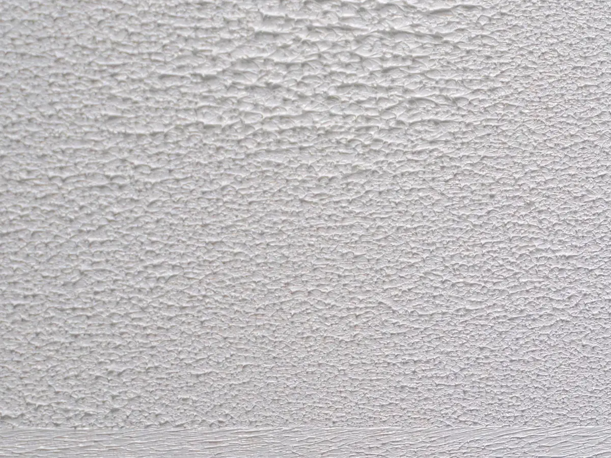 White textured ceiling coating with a raised pattern