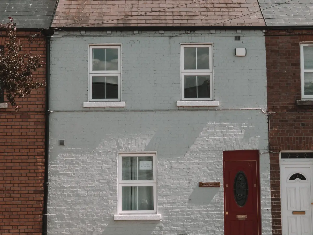 Compact brick house with a bright front door