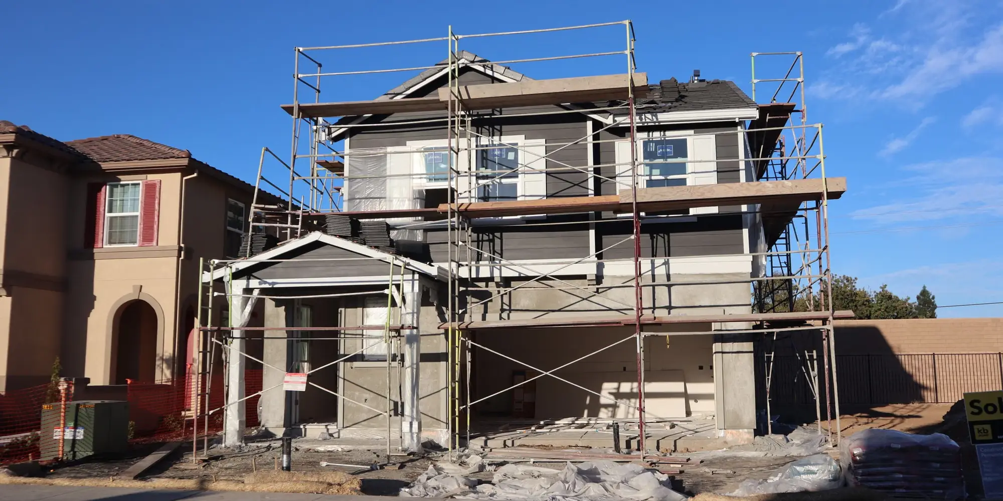Two-storey house wrapped in scaffolding ready for rendering