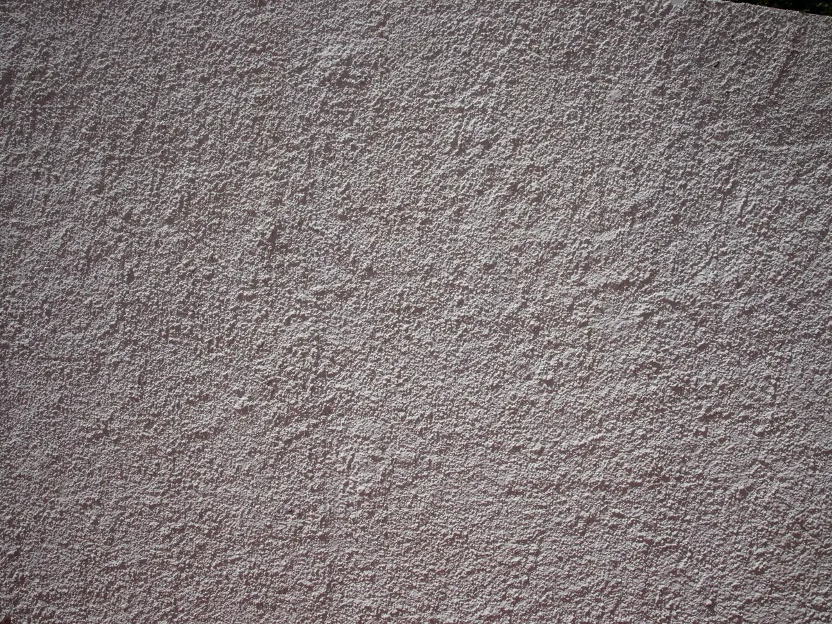 Dark scraped monocouche render texture close up