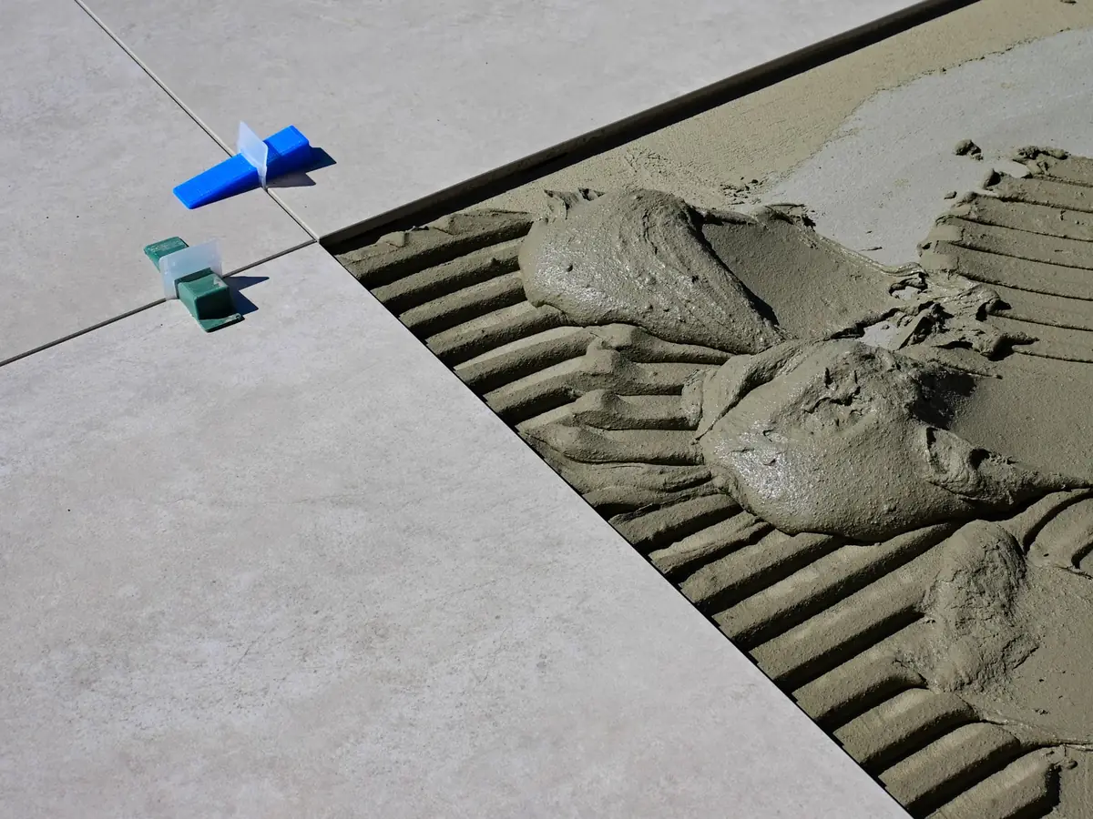 Tile spacers and adhesive on a prepared floor
