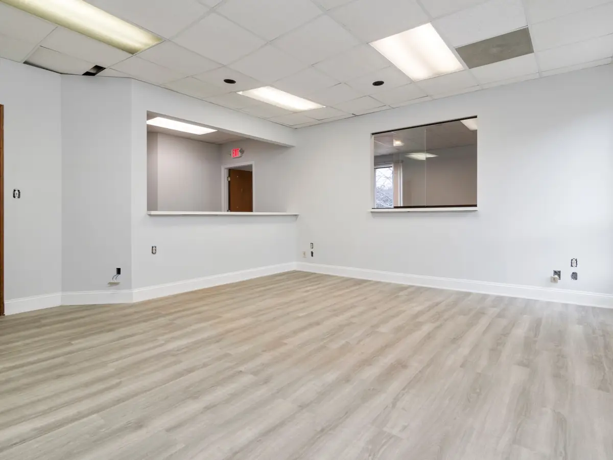 Empty room with a new timber floor and recessed lighting