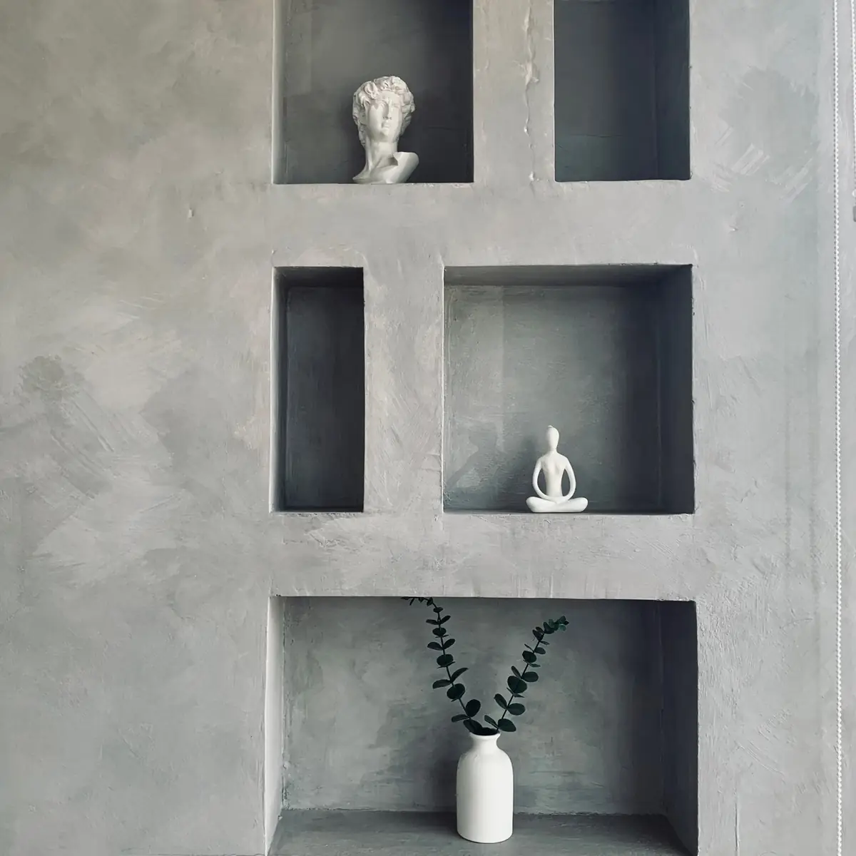 Grey polished plaster wall with display niches