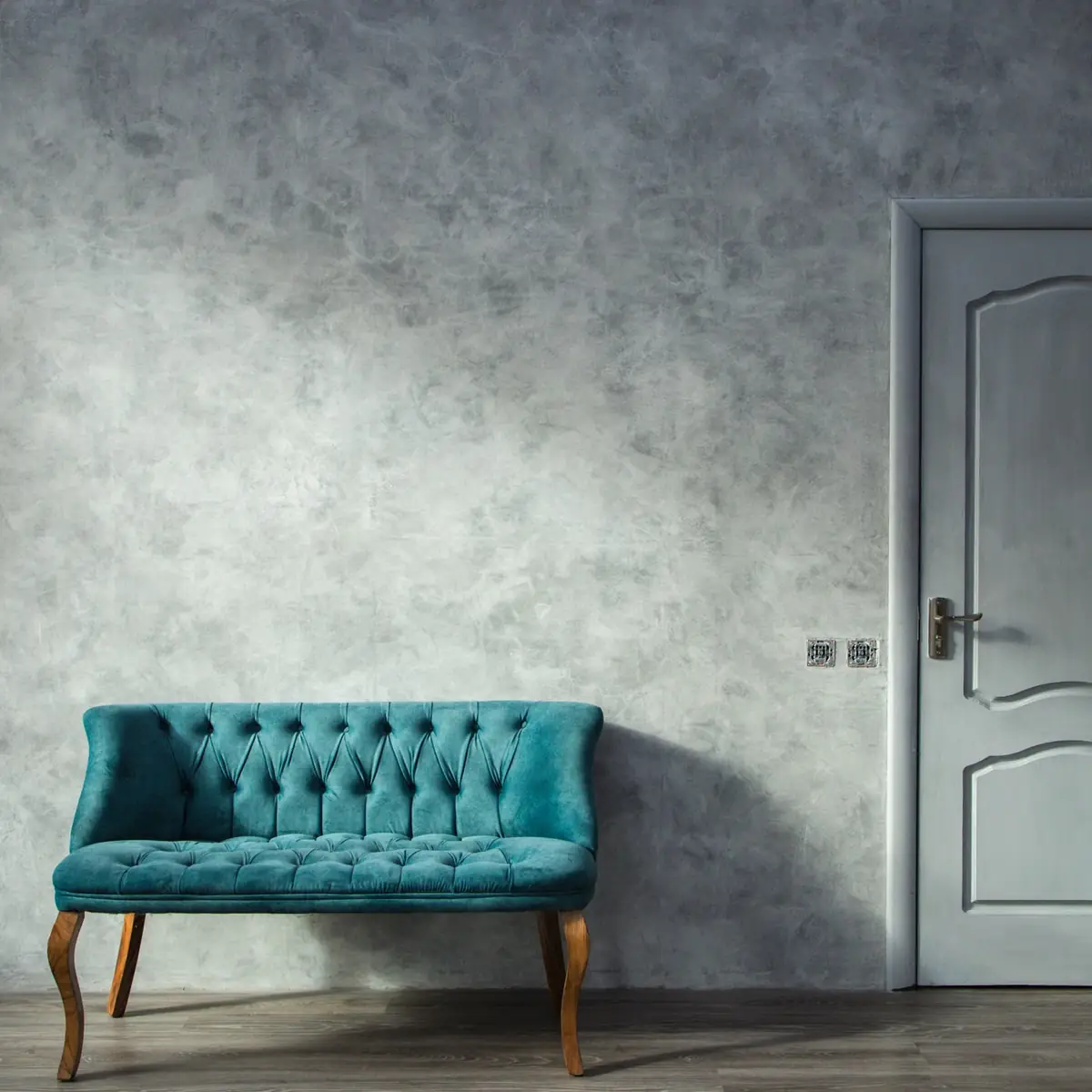 Sofa against a grey polished wall